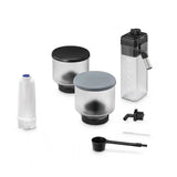 Taghareed De'Longhi Rivelia coffee machine accessories: two bean hoppers, water tank, filter, scoop, and cleaning tool.