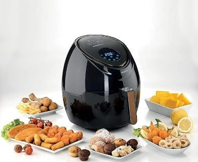 Taghareed black 5.5L digital air fryer with touch screen, 1800W, surrounded by various foods.