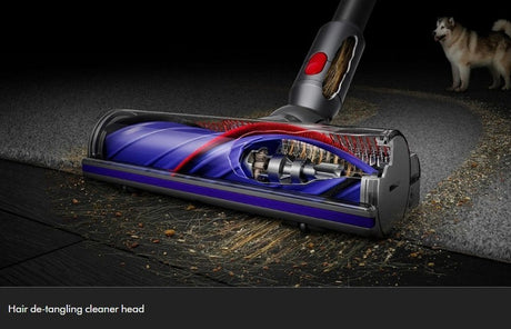 Taghareed Dyson V12s Detect Slim Submarine vacuum cleaner with hair de-tangling cleaner head on carpet and wood floor.