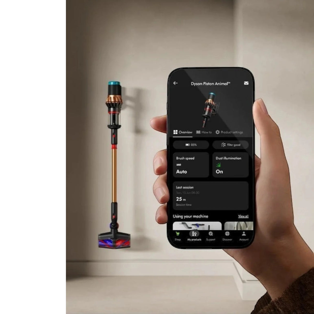 Taghareed Dyson V16 Piston Animal Submarine cordless vacuum in copper and black, with app interface on phone.