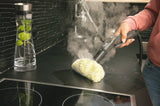 Taghareed Karcher SC 4 EasyFix steam cleaner with yellow microfiber pad cleaning a black stovetop. Steam is visible.