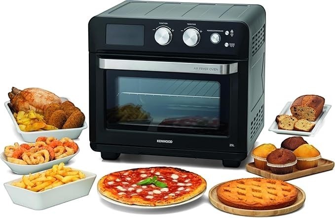 Taghareed Kenwood 25L black 2-in-1 air fryer oven with digital display, 1700W, 15 programs. Shows cooked chicken, fries, pizza, and baked goods.