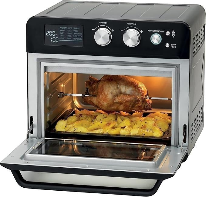 Taghareed Kenwood 25L digital air fryer oven with rotisserie chicken and roasted potatoes inside.