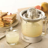 Taghareed Kenwood JE290 white 40W citrus juicer with 1L clear jug and stainless steel filter. Includes glass of juice.
