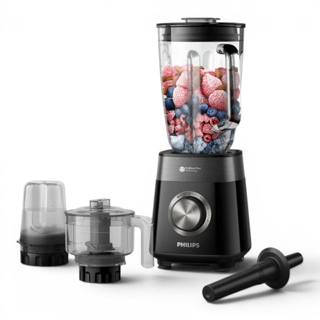 Taghareed Philips 5000 Series blender with 2L glass jar filled with berries and ice, includes grinder and chopper attachments.
