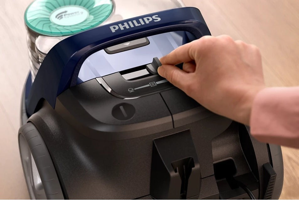 Taghareed Philips 5000 Series bagless vacuum cleaner with PowerCyclone 7 and TriActive nozzle, dark grey and blue.