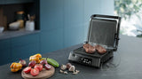 Taghareed Philips 7000 Series electric contact grill with temperature probe cooking two steaks, digital display showing 55°C.