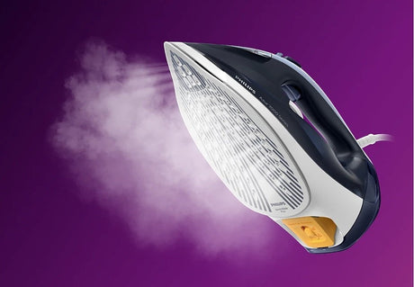Taghareed Philips 7000 Series steam iron with SteamGlide Plus soleplate, releasing steam. Dark blue and white.