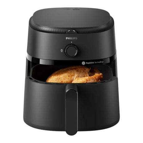 Taghareed Philips Airfryer 1000 Series NA130/09, black, 6.2L capacity, with Rapid Air Technology, cooking a whole chicken.