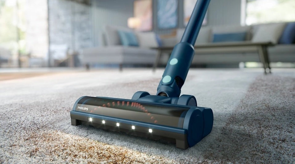 Taghareed Philips 5000 Series Aqua cordless vacuum with TriActive Multi LED nozzle cleaning carpet.