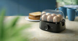 Taghareed Philips 3000 Series HD9137/91 black egg cooker with clear lid, steams up to 6 eggs or 3 poached eggs.