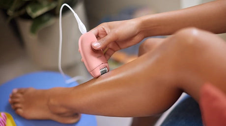 Taghareed Philips Epilator Series 2000 BRE229/00 in rose gold, used on a leg for smooth skin. Corded, compact design.