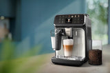 Taghareed Philips 4400 Series espresso machine with LatteGo system, making a latte macchiato. Features TFT display.