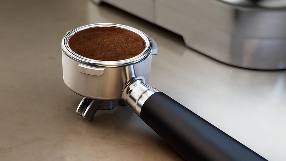 Taghareed Philips Barista Brew semi-automatic espresso machine portafilter with ground coffee, 58mm stainless steel basket.