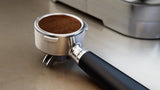 Taghareed Philips Barista Brew semi-automatic espresso machine portafilter with ground coffee, 58mm stainless steel basket.