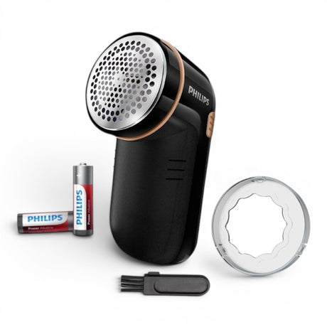 Taghareed Philips Fabric Shaver GC026/80, black with gold accents, includes batteries and cleaning brush.
