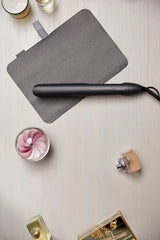 Taghareed Philips 5000 Series black hair straightener with argan-oil infused plates and ThermoShield technology.