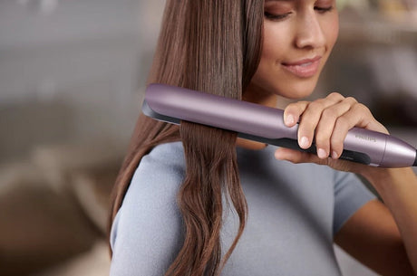 Taghareed Philips 5000 Series purple hair straightener with ThermoShield technology and 2x Ionic Care.