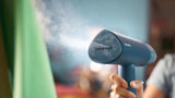 Taghareed Philips 3000 Series handheld steamer, blue, compact and foldable, for quick wrinkle removal and garment refreshing.