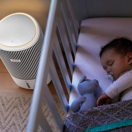 Taghareed Philips PureProtect Water 3400 Series AC3420/10 air purifier and humidifier in a nursery next to a sleeping baby.