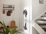 Taghareed Philips SpeedPro Max stick vacuum cleaner in rose gold and black, mounted on wall charger. Features 360° nozzle and digital display.
