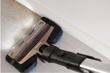Taghareed Philips SpeedPro Max vacuum cleaner head with LED lights cleaning dust from floor edge.