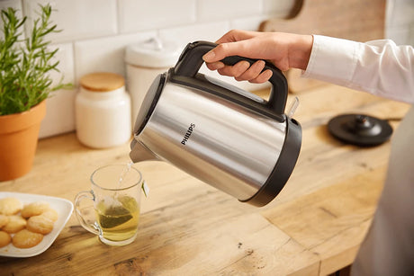 Taghareed Philips stainless steel electric kettle with black handle and water level indicator, 1.7L capacity, 2200W power.
