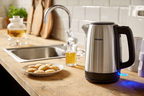 Taghareed Philips stainless steel electric kettle with black handle and water level indicator, 1.7L capacity, 2200W power.