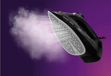 Taghareed Philips 5000 Series steam iron with SteamGlide Plus soleplate, emitting steam.