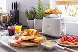 Taghareed white Philips 2-slice toaster with bun rack, 8 browning settings, defrost & reheat functions.