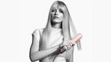 Tagharid Ceramic Pink/Rose Gold Dyson Airstrait hair straightener with model styling long blonde hair. Wet to dry styling.